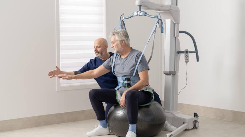 Arjo Maxi Move 5 mobile patient floor lift shown during a patient transfer