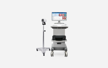 EDAN HD video colposcope camera on a floor stand beside a cart with monitor and printer