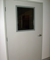 Ray-Bar lead-lined hollow-metal shielding door installation with vision panel, official manufacturer product-family photograph
