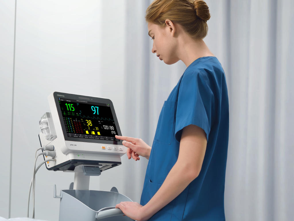 Mindray ePM 12M bedside monitor on a trolley with a healthcare professional, manufacturer reference arrangement